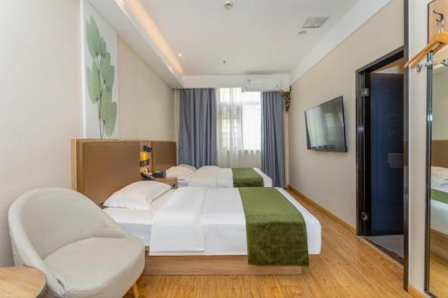 a hotel room with a bed and a chair at GreenTree Inn in Shanghai