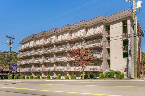 an apartment building on the corner of a street at Sleep Inn & Suites near Sports World Blvd in Gatlinburg