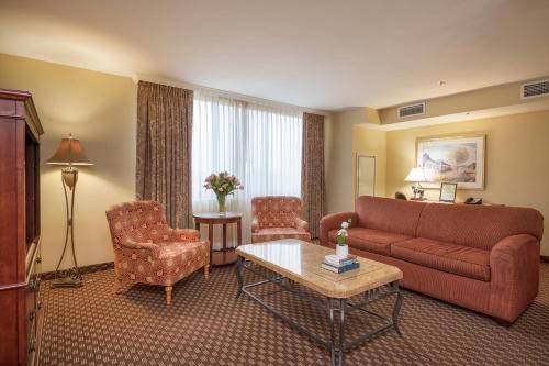 a living room with a couch and a table at Clarion Collection Hotel Arlington Court Suites in Arlington