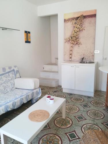 a living room with a couch and a table at Vista Castello - Otranto in Otranto