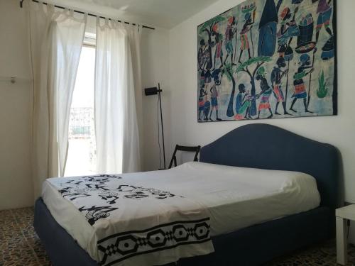 a bedroom with a bed and a painting on the wall at Vista Castello - Otranto in Otranto