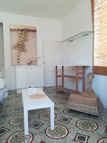a living room with a table and a piano at Vista Castello - Otranto in Otranto