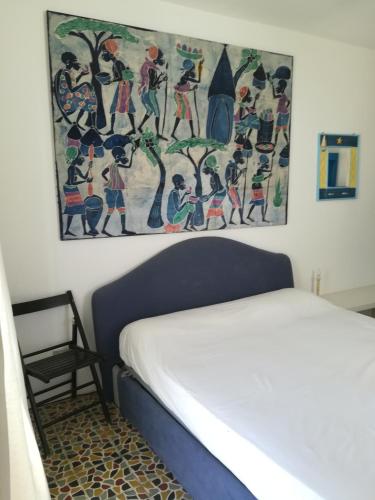 a bedroom with a painting above a bed at Vista Castello - Otranto in Otranto