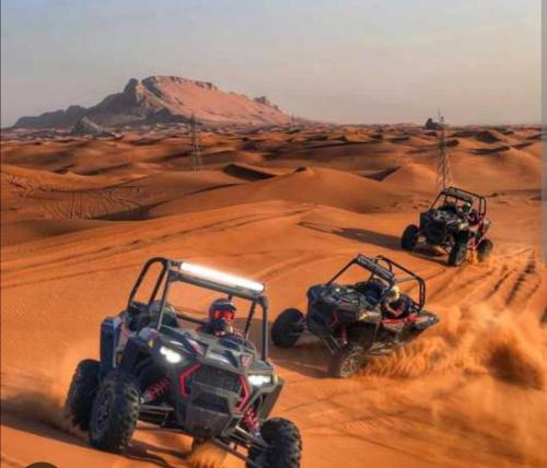 two atvs andacs driving in the desert at Riad dar asalam in Agadir