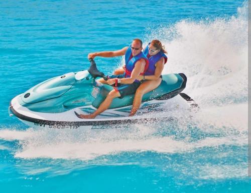 a man and woman riding a jet ski in the water at Riad dar asalam in Agadir