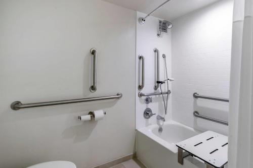 a white bathroom with a toilet and a sink at Quality Inn Lexington -Horse Park in Lexington