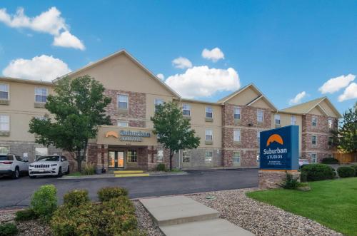 a rendering of an apartment building with a parking lot at Suburban Studios Denver Central-Arvada in Arvada