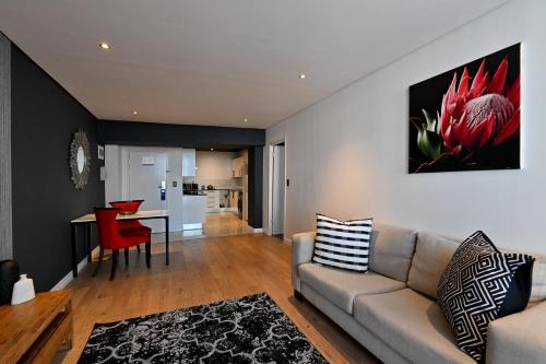 a living room with a couch and a table at Fountains Hotel in Cape Town
