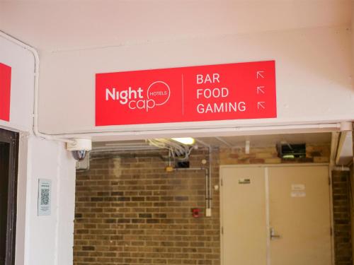 a red sign on the wall of a building at Nightcap at Hinterland Hotel Nerang in Gold Coast