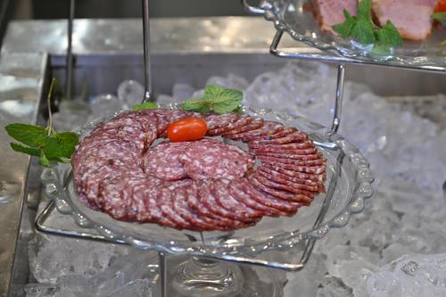 a plate of meat with a tomato on top at Fountains Hotel in Cape Town