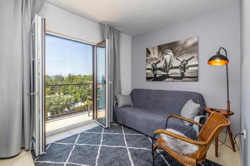 a living room with a couch and a balcony at Bellona in Malinska
