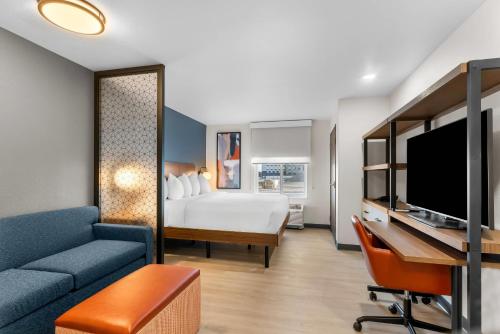 a hotel room with a bed and a desk at Everhome Suites Cheyenne in Cheyenne