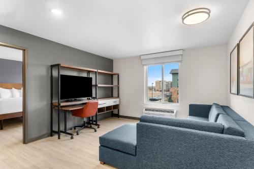 a living room with a couch and a tv at Everhome Suites Cheyenne in Cheyenne