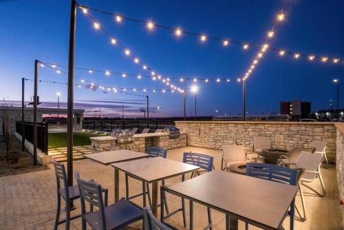 a patio with tables and chairs and lights at Everhome Suites Cheyenne in Cheyenne