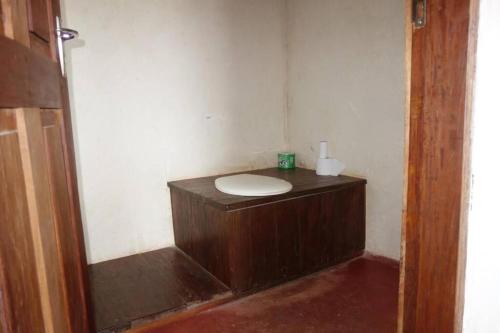 a bathroom with a wooden sink in a room at Juani Pangani in Pangani