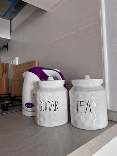 two white jars sitting on a kitchen counter at Apartment Laura in Senj