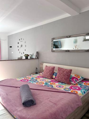 a bedroom with a large bed with a purple blanket at Apartment Laura in Senj