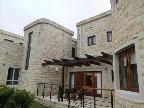 a brick building with a patio in front of it at Castle On The Heads in Knysna