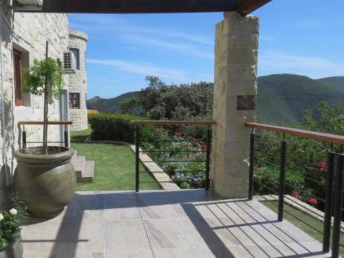a view from the balcony of a house with a plant at Castle On The Heads in Knysna