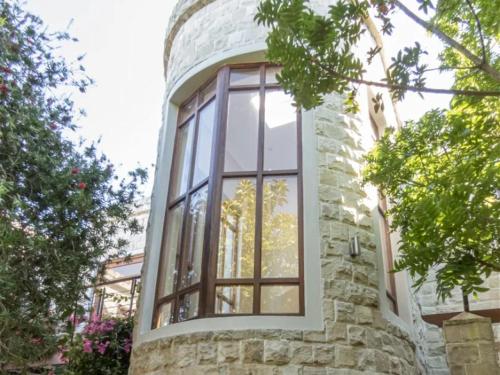 a window on the side of a stone building at Castle On The Heads in Knysna