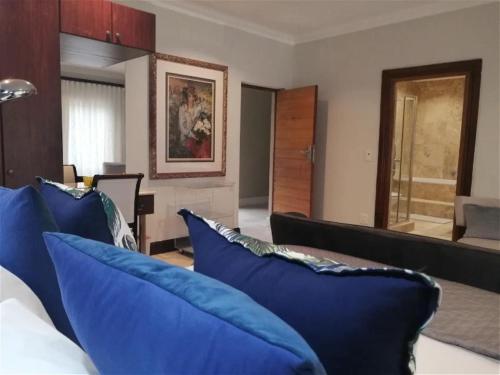a living room with blue pillows on a couch at Castle On The Heads in Knysna
