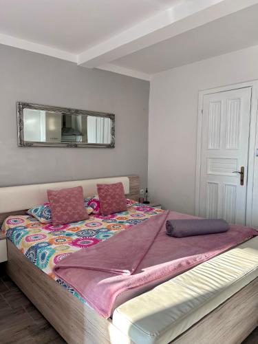 a large bed in a room with a mirror at Apartment Laura in Senj