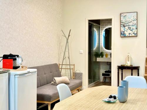 a living room with a couch and a table at Historical Center - Taipas Apartments in Porto