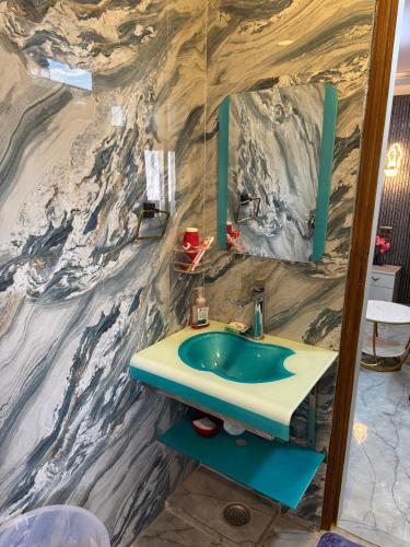a bathroom with a sink and a mirror at Urban Nest in Dehradun