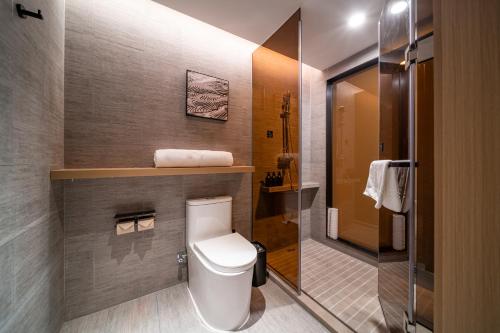a small bathroom with a toilet and a shower at Atour Hotel Shenzhen Luohu Vientiane City in Shenzhen