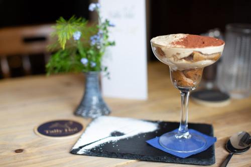 a dessert in a wine glass sitting on a table at Tally Ho! in Hatherleigh
