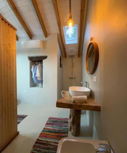 a bathroom with a sink and a mirror at Villa Tilda in Argyrátika