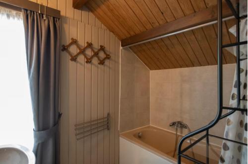 a bathroom with a tub and a shower curtain at Golfchalets Evergreen - Four Seasons in Durbuy
