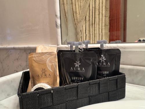 a black basket with three bags on a counter at Deluxe Oliver's House in Venice