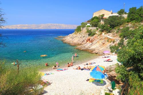 a group of people laying on a beach at Seabreeze Apartments with Shared Jacuzzi in Senj