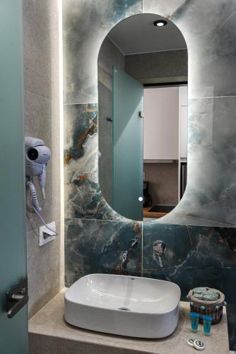 a bathroom with a sink and a mirror at Porto Psakoudia in Psakoudia
