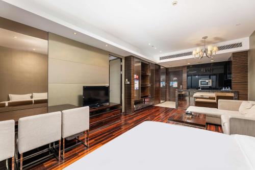 a living room with a couch and a television at Bulgari Serviced Residences Guangzhou in Guangzhou