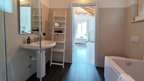 a bathroom with a sink and a shower and a tub at Villa Selva in Bellagio
