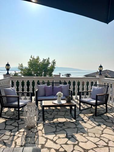 a patio with a couch and two chairs and a table at Apartment Laura in Senj
