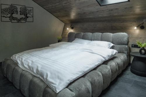 a large bed in a bedroom with a large bed frame at Lago House Bran in Bran