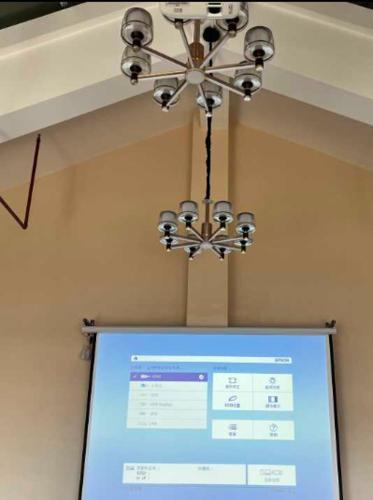 a chandelier hanging over a projection screen in a room at Lavande Hotel Shenzhen International Convention and Exhibition Center Fuhai West Subway Station in Shenzhen
