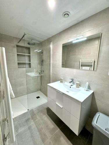 a white bathroom with a sink and a shower at Maison avec jardin et proche mer in Propriano