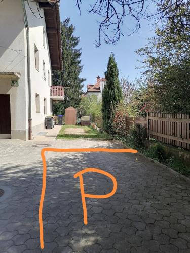 a parking lot with orange lines on a driveway at Pirc apartment on Dunajska street in Ljubljana