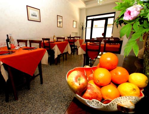 a bowl of fruit on a table in a restaurant at Albergo Umbria in Città di Castello
