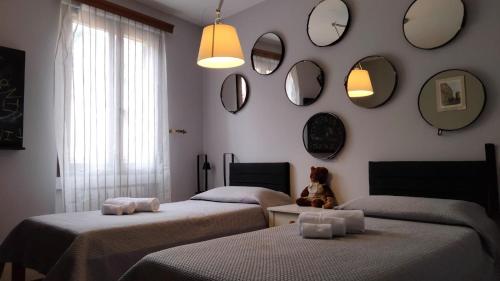 a room with three beds and mirrors on the wall at Vesto VISTA in Marone