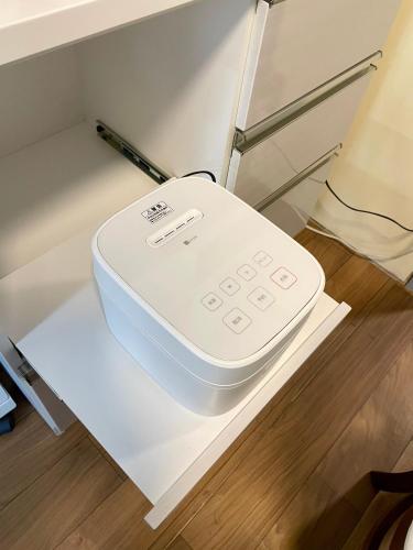 a remote control sitting on a shelf in a drawer at サニーサイドホステル1号館 in Uji