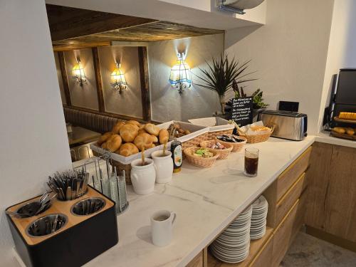 a kitchen counter with a bunch of food on it at Pension Lederergütl - Jokercard & Parkplatz inkl in Saalbach Hinterglemm