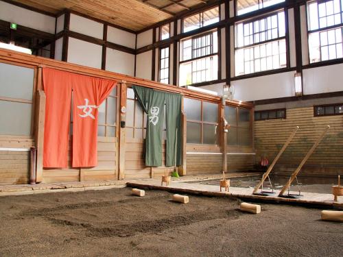 a large room with flags hanging in a building at Calm house Beppukitahama in Beppu