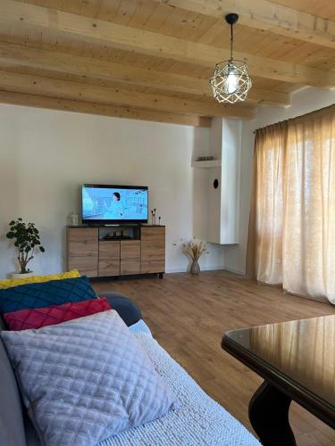 a living room with a couch and a flat screen tv at Vikendica Diva 