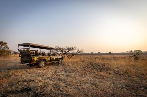 a jeep parked in the middle of a field at Rain Tree Camp in Chunga