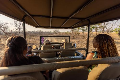 a group of people riding in a safari bus at Rain Tree Camp in Chunga